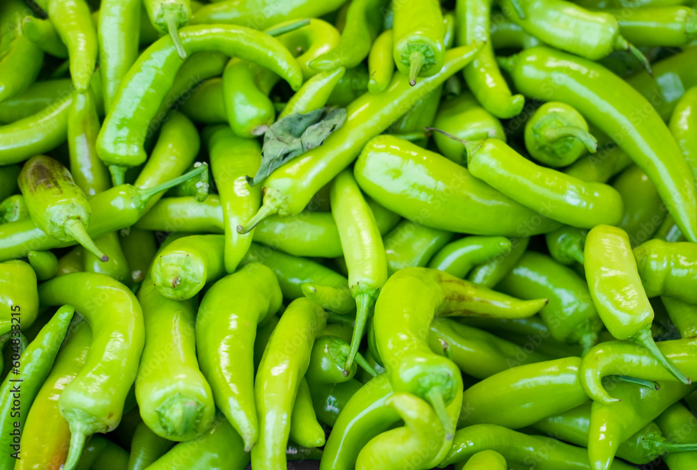 Green chilli close-up. Fresh Vegetables Background. Chili peppers.
Green chilli close-up. Fresh Vegetables Background. Chili peppers.