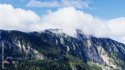 Panoramic mountain landscape. Mountain stone peaks in the clouds on a sunny day. © makedonski2015