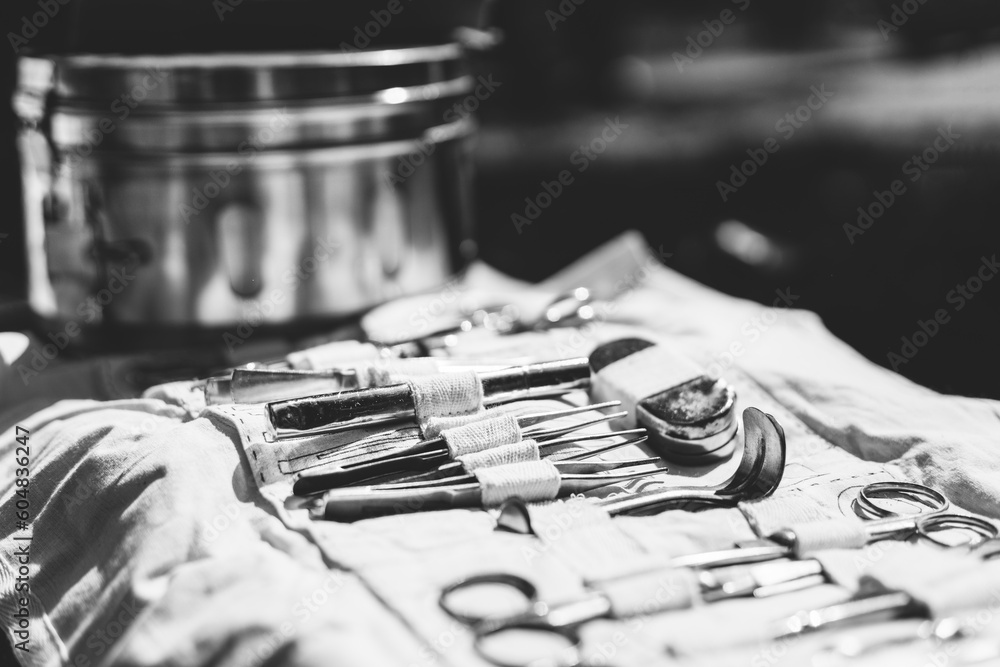 Old Medical And Surgical Instruments. Many Surgical Instruments For Surgery. Old Different Metal Medical Instruments Objects. Retro Stainless Surgical Equipment Tools. Black And White Toned Shot