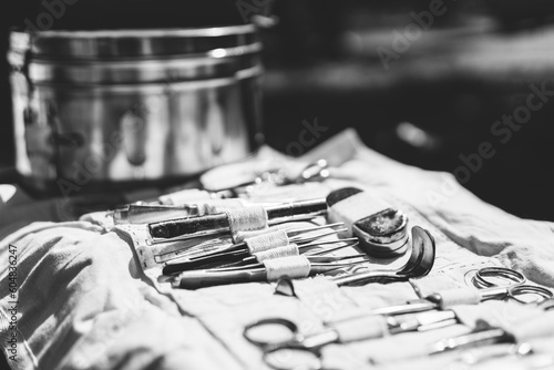 Obraz na płótnie Old Medical And Surgical Instruments. Many Surgical Instruments For Surgery. Old Different Metal Medical Instruments Objects. Retro Stainless Surgical Equipment Tools. Black And White Toned Shot w salonie