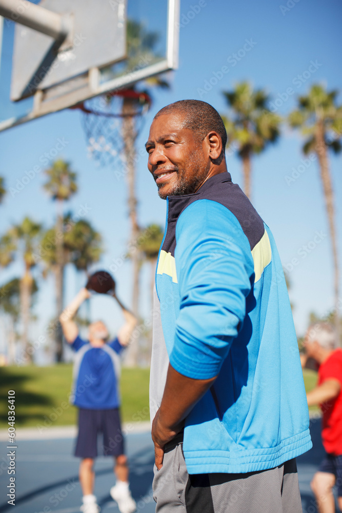 Older man playing basketball on court Older man playing basketball on court