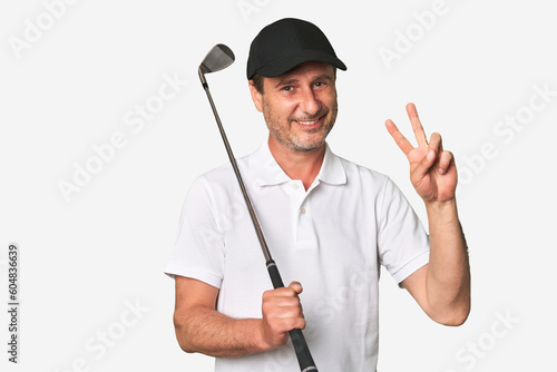 Middle aged golfer man joyful and carefree showing a peace symbol with fingers.