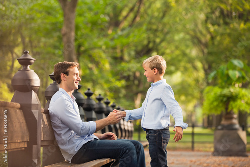 Father and son in urban park