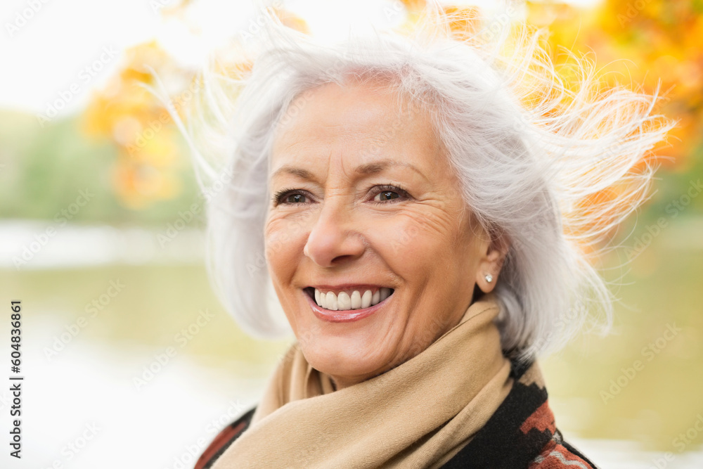 Smiling older woman standing in park