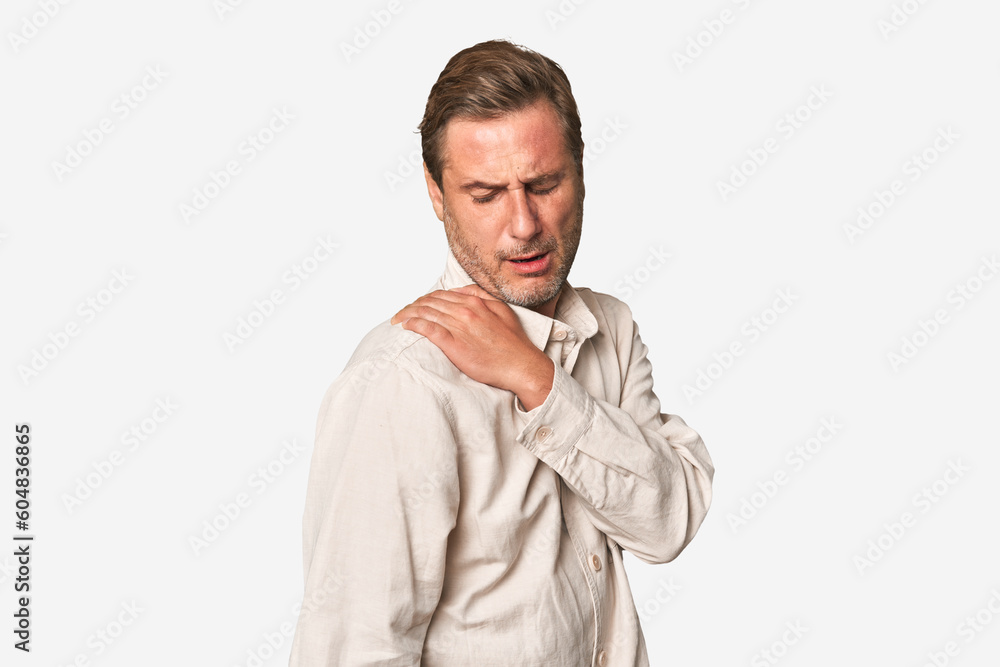 A middle-aged man isolated having a shoulder pain. A middle-aged man isolated having a shoulder pain.