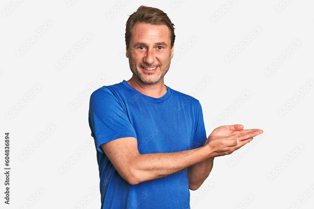 A middle-aged man isolated holding a copy space on a palm. A middle-aged man isolated holding a copy space on a palm.