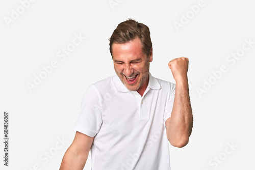 A middle-aged man isolated dancing and having fun.