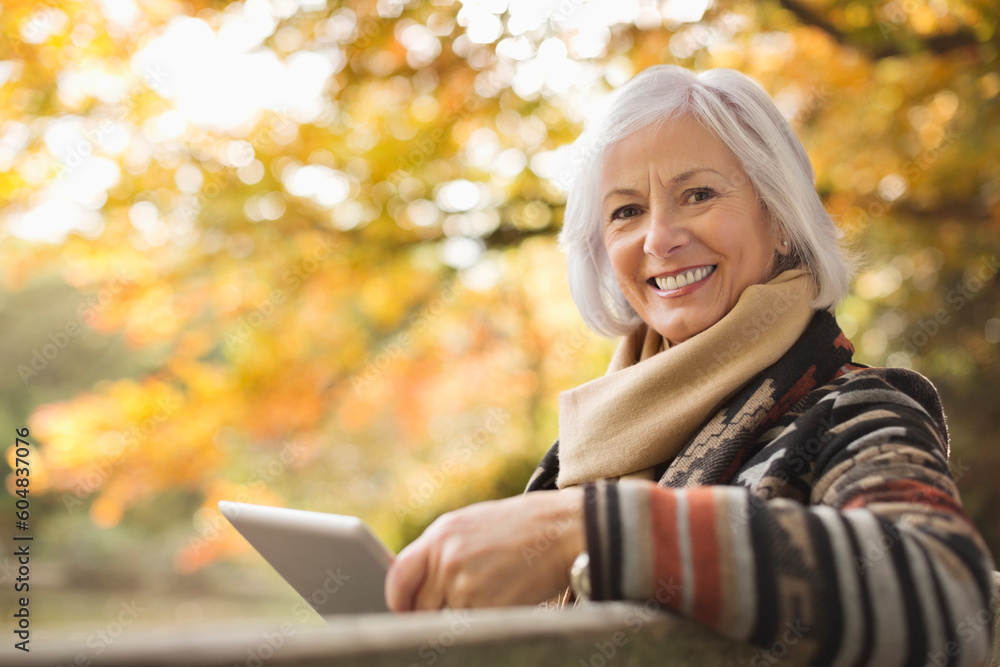 Older woman using tablet computer outdoors Older woman using tablet computer outdoors
