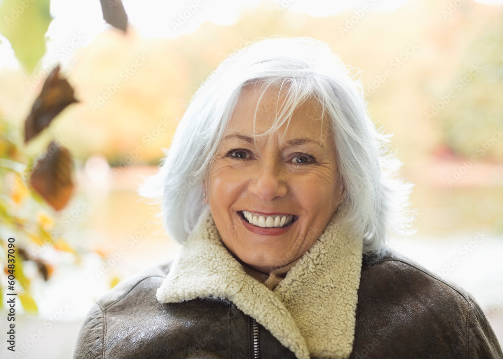 Smiling older woman standing outdoors Smiling older woman standing outdoors