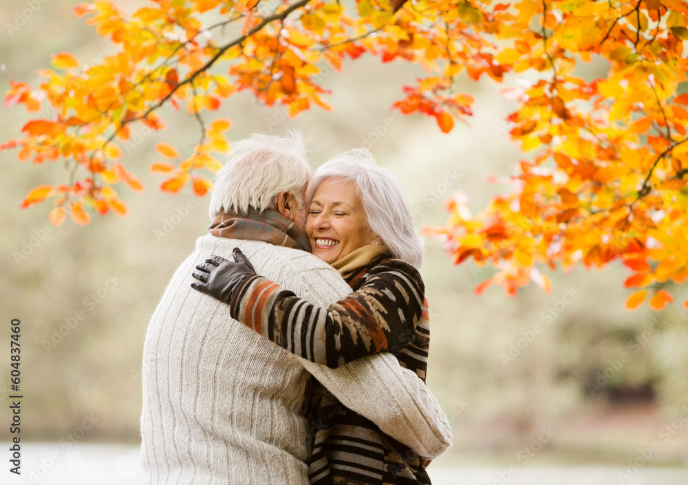 Older couple hugging in park Older couple hugging in park