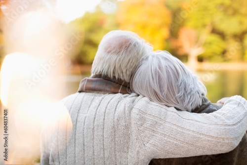 Older couple hugging in park
