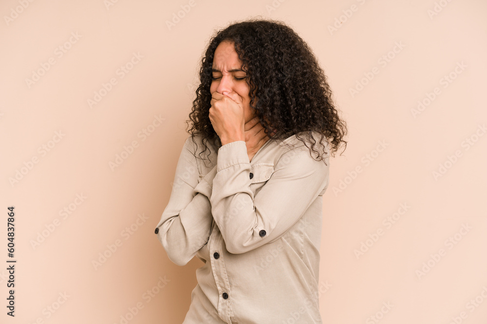 Young african american curly woman isolated suffers pain in throat due a virus or infection. Young african american curly woman isolated suffers pain in throat due a virus or infection.