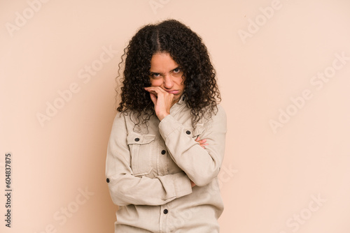 Young african american curly woman isolated tired of a repetitive task. © Asier