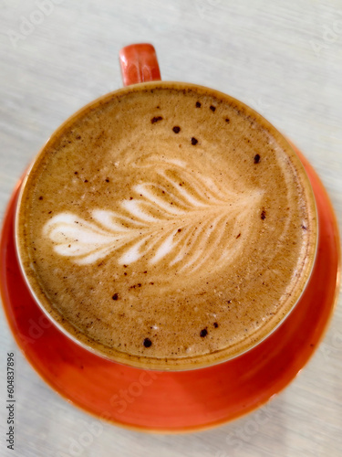 Top view of cappuccino coffee in a beautiful ceramic cup.