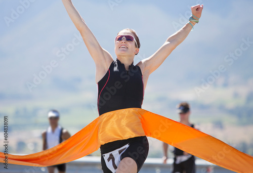 Runner crossing race finish line photo