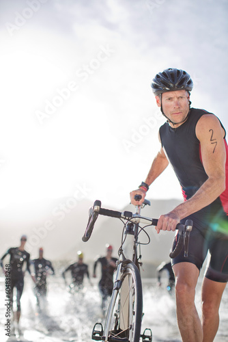 фотографія Man pushing bicycle on beach