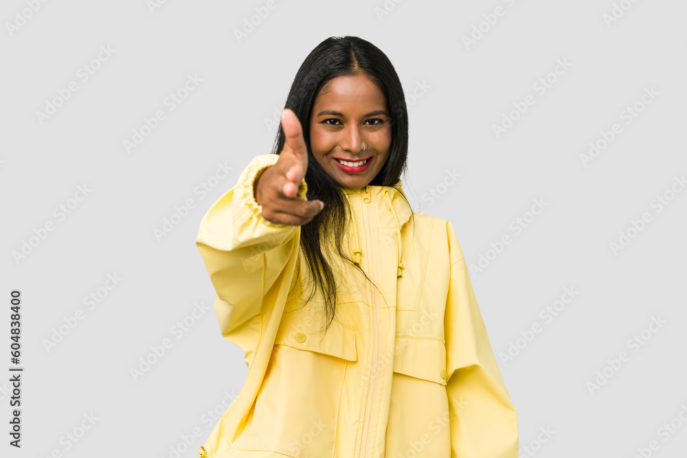 Young Indian woman cut out isolated on white background smiling and raising thumb up Young Indian woman cut out isolated on white background smiling and raising thumb up
