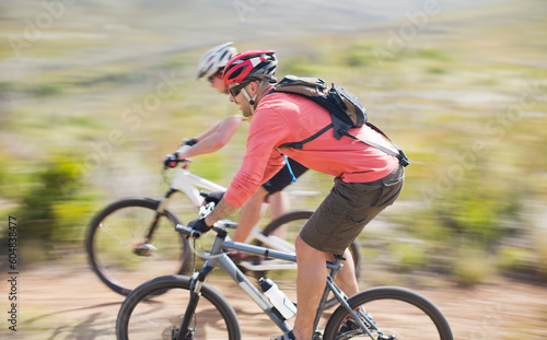 Blurred view of mountain bikers on dirt path