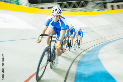 Track cyclist racing in velodrome photo