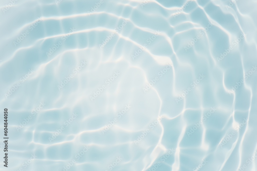 Fototapeta premium Blue water with ripples on the surface. Defocus blurred transparent blue colored clear calm water surface texture with splashes and bubbles. Water waves with shining pattern texture background.