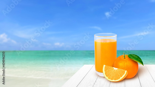 Glass of orange juice with fresh fruit on white wooden table with sea beach and blue sky blurred background. Summer and vacation concept.