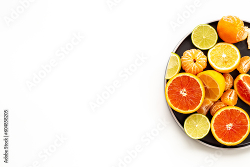 Many mixed fruits on white plate  top view
