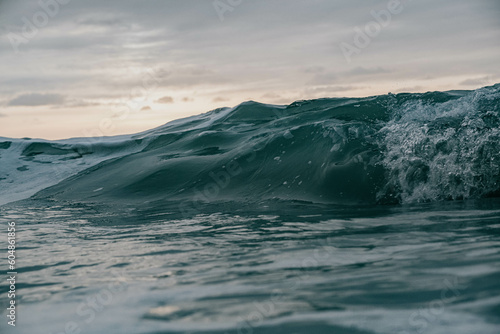 Fototapeta Naklejka Na Ścianę i Meble -  Sun behind the high waves in the sea