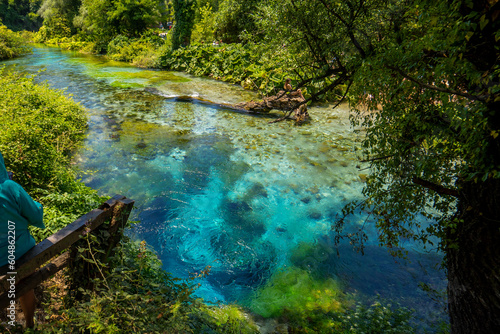 The Blue Eye Albanian  Syri i Kalter  is a water spring near Muzine in Vlore County  southern Albania. A popular tourist attraction. The water bubbles from a more than fifty meter deep pool.