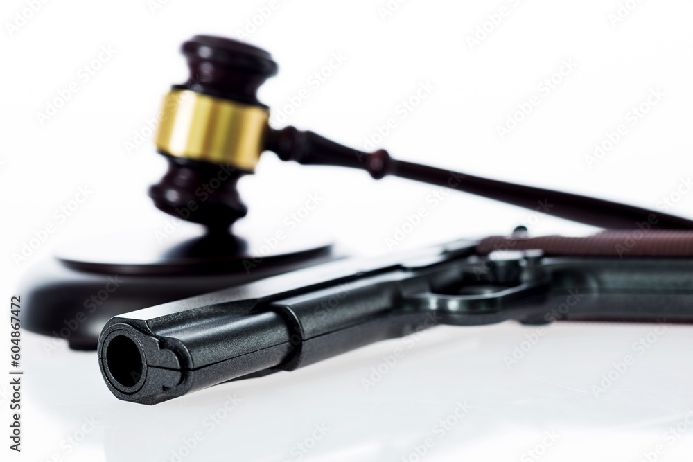 A gavel and gun isolated on white background A gavel and gun isolated on white background