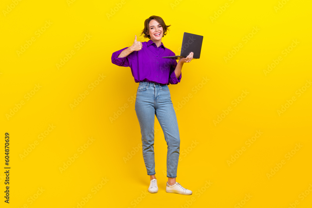 Full size photo of young professional agent lady bob brown hair wear purple shirt like her netbook job isolated on yellow color background Full size photo of young professional agent lady bob brown hair wear purple shirt like her netbook job isolated on yellow color background