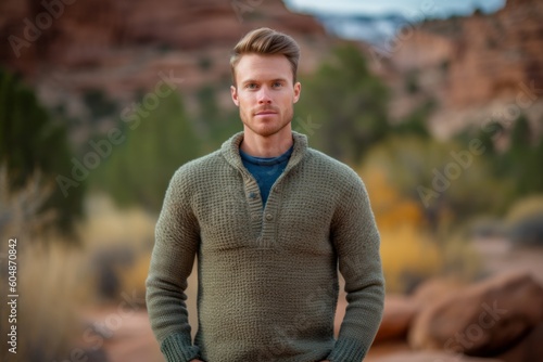 Lifestyle portrait photography of a satisfied boy in his 30s wearing a cozy sweater against a national park background. With generative AI technology