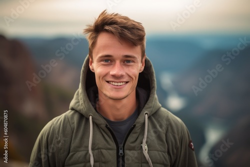 Close-up portrait photography of a grinning boy in his 30s wearing a cozy zip-up hoodie against a national park background. With generative AI technology