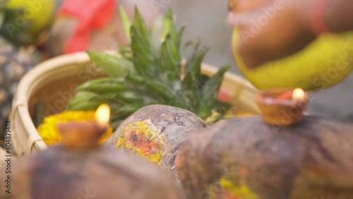 Indian man setting up fruits for God photo