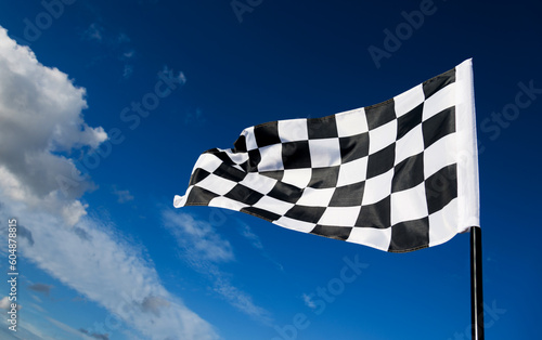 Checkered flag on blue sky