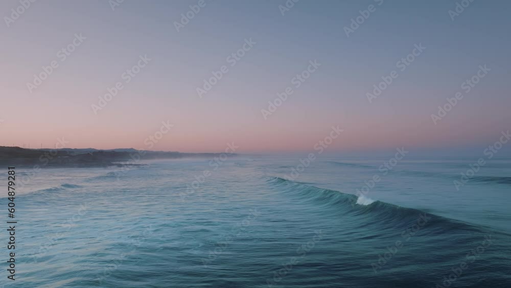 Pink sunset sky over turquoise ocean waves. Evening sun and clear blue sea. Aerial view of summer sunset seascape. Pink sunset sky over turquoise ocean waves. Evening sun and clear blue sea. Aerial view of summer sunset seascape.