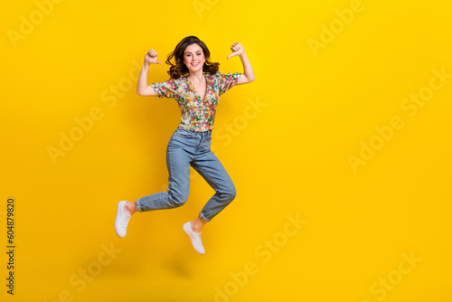 Full body photo of jump funky girl wear denim jeans stylish blouse pointing fingers herself best model isolated on yellow color background