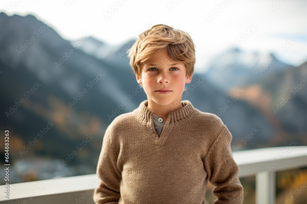 Lifestyle portrait photography of a glad kid male wearing a cozy sweater against a scenic mountain overlook background. With generative AI technology