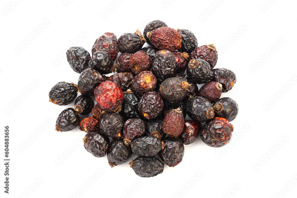 Heap of red dry rose hips isolated on a white background. Heap of red dry rose hips isolated on a white background.