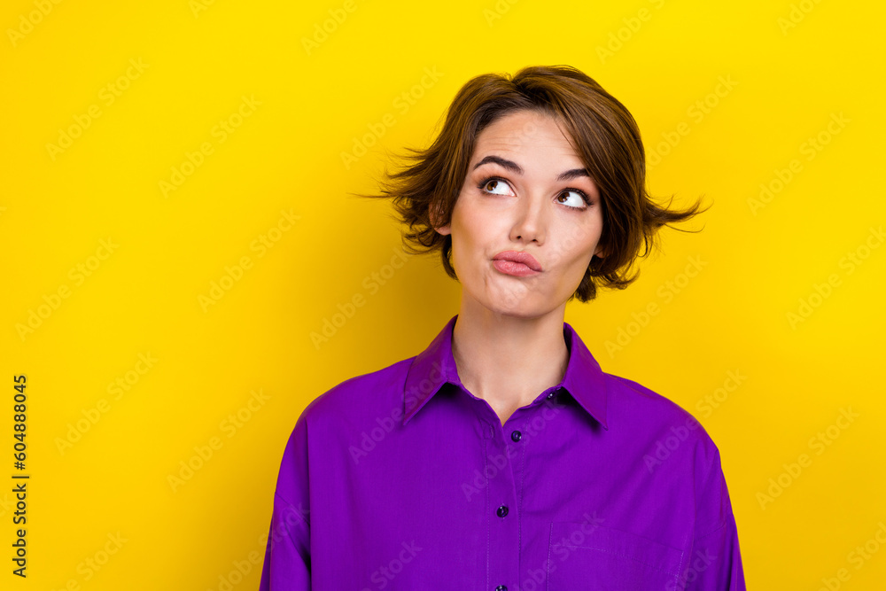 Portrait of business lady worker look up empty space have doubts wear elegant violet shirt isolated yellow bright color background Portrait of business lady worker look up empty space have doubts wear elegant violet shirt isolated yellow bright color background