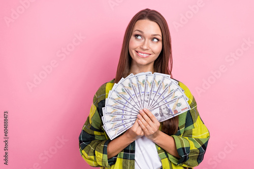 Photo of young business lady work hard get big income savings much money dollars banknotes look empty space lottery isolated on pink color background