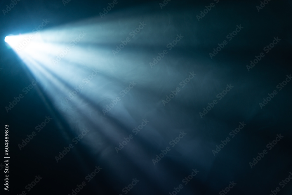 blue spotlight light beam on black background