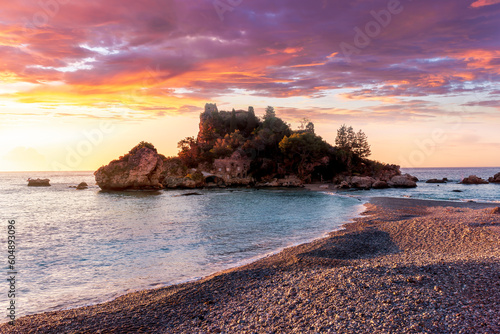 travel landscape of beautiful isle among blue sea waves and colorful cloudy sky on background