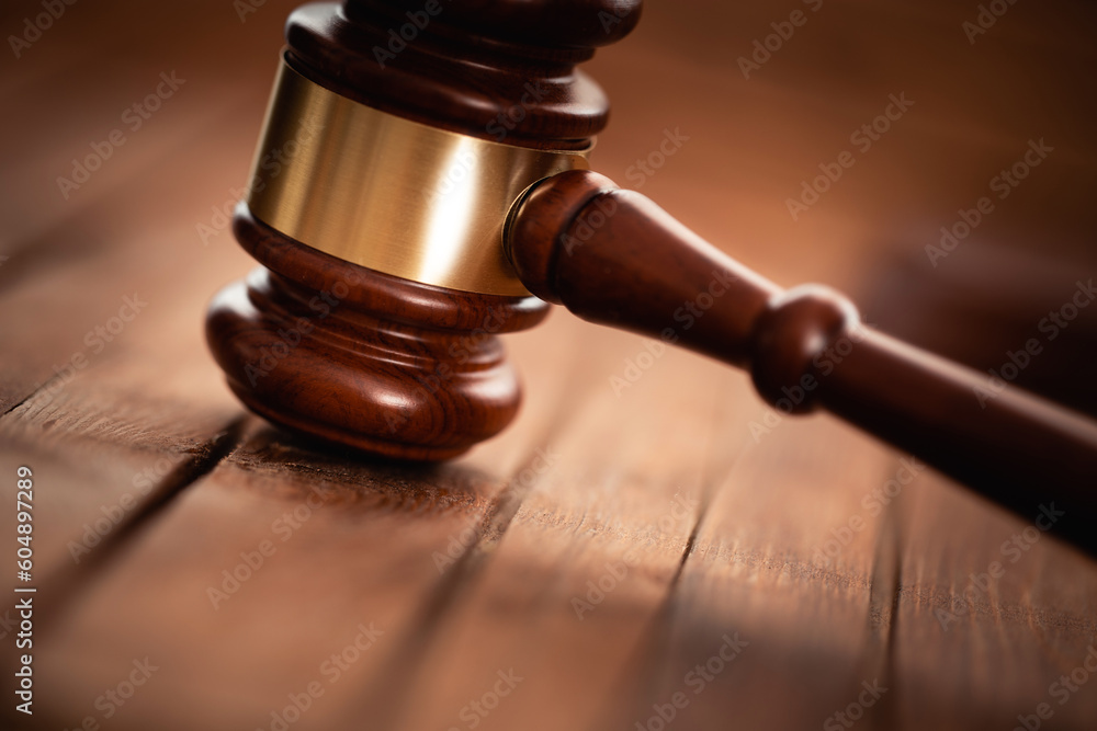 Judge gavel closeup on a wooden surface, concept of law and justice Judge gavel closeup on a wooden surface, concept of law and justice