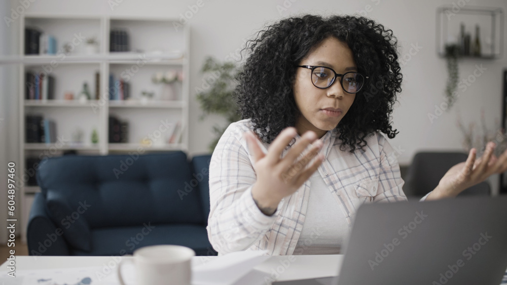 Anxious African American woman having problems with work tasks, correcting errors on her laptop