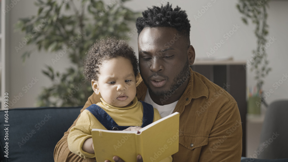Loving father reading fairytale to little son, upbringing, parental care Loving father reading fairytale to little son, upbringing, parental care