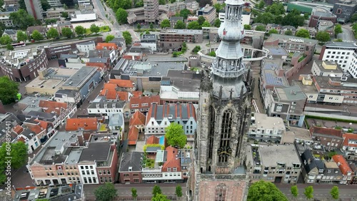 This aerial drone video shows the Lieve Vrouwentoren, a large clock tower in the old city center of Amersfoort. Amersfoort is a beautiful city in Utrecht, the Netherlands. photo