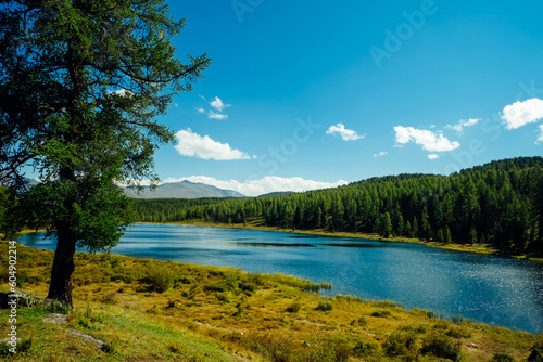 Mountain natural scenery. Clean lake water and blue sky in sunlight.