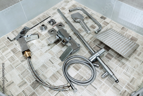 Plumbing accessories in the bathroom. Water faucet, hoses, shower head, water faucet. Items for wall mounting and connection.
