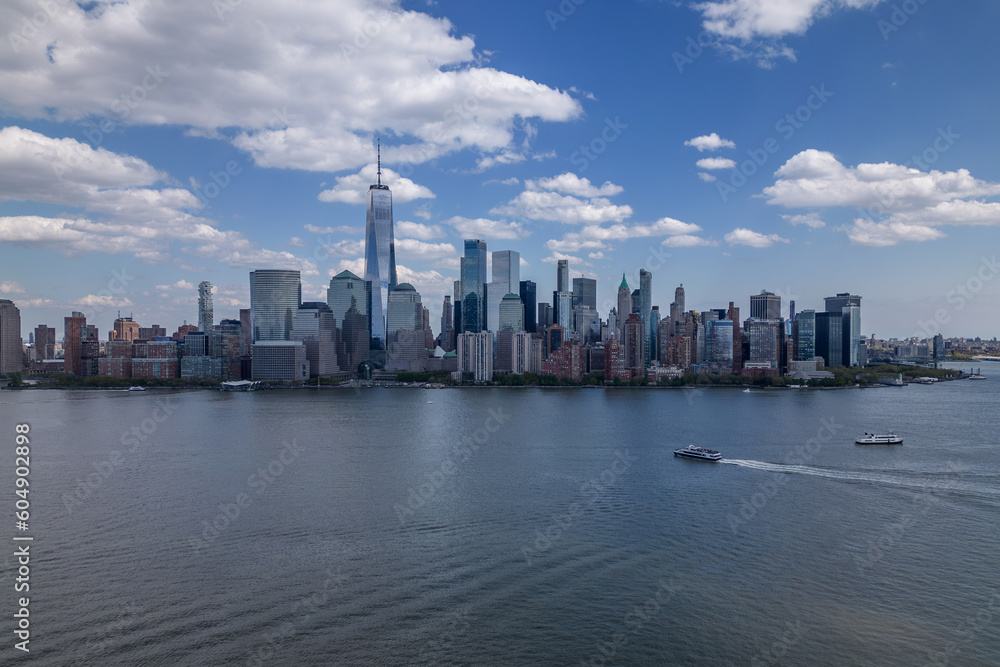 A boat in the water with the manhattan skyline in the background