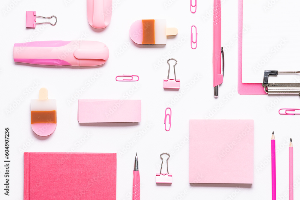 Pink stationery set on light white background. Seamless pattern, top view. Back to school background. Creative office desktop. Pink stationery set on light white background. Seamless pattern, top view. Back to school background. Creative office desktop.